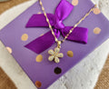 Collier pendentif fleur et strass tournante